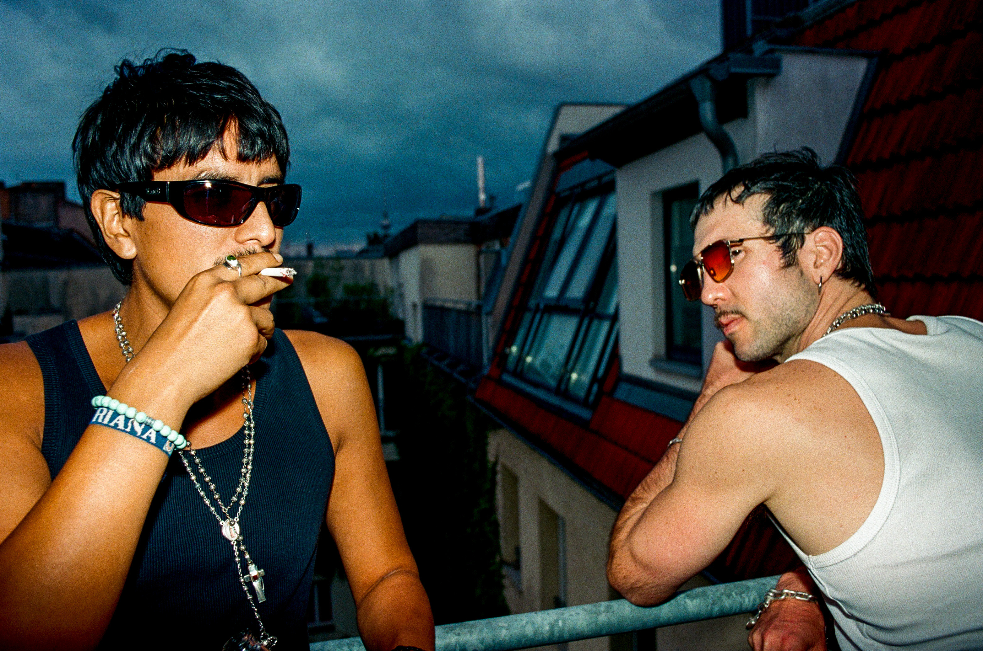 Two people in sunglasses on a rooftop