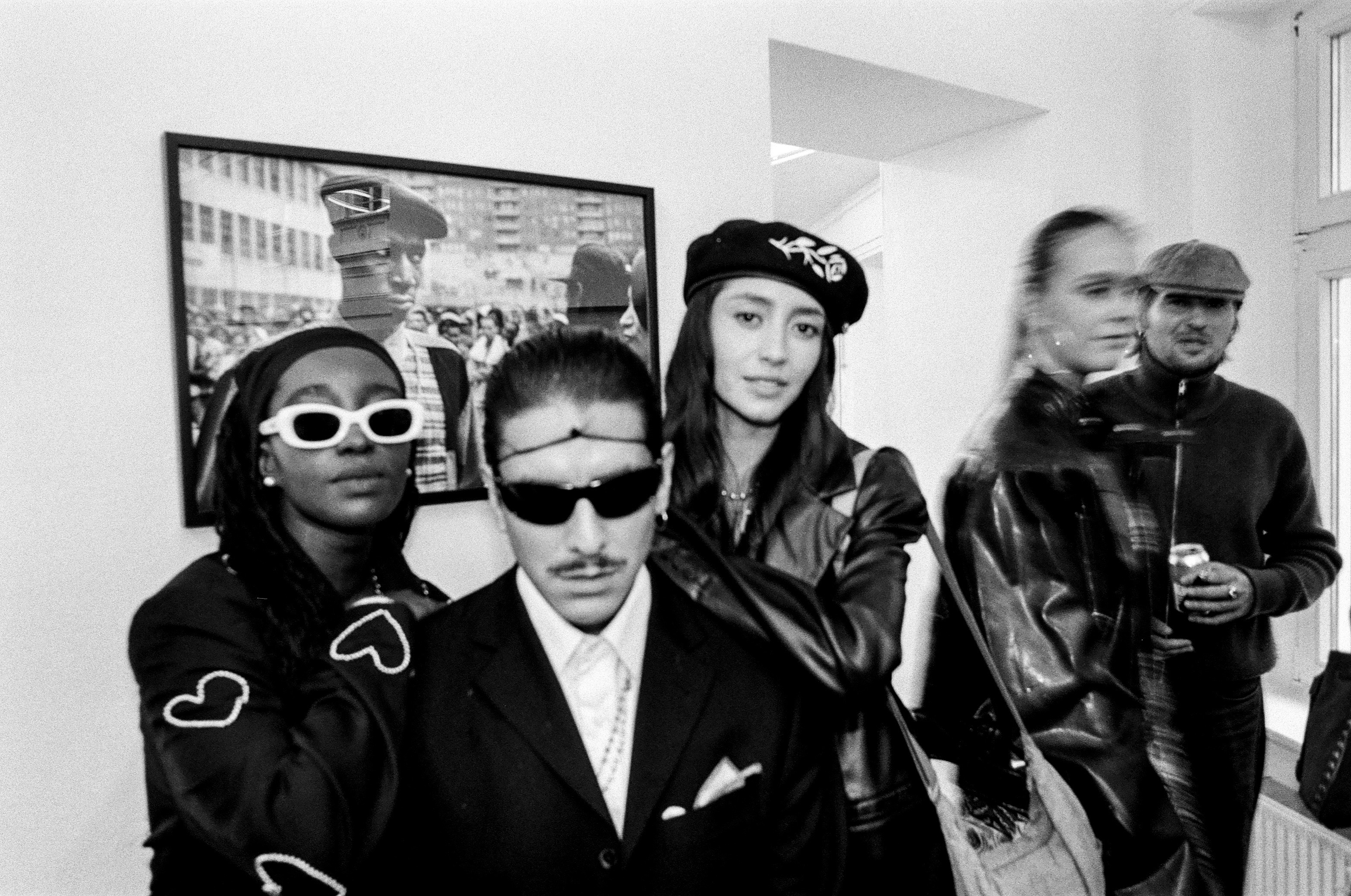 Friends gathered in a room in black and white