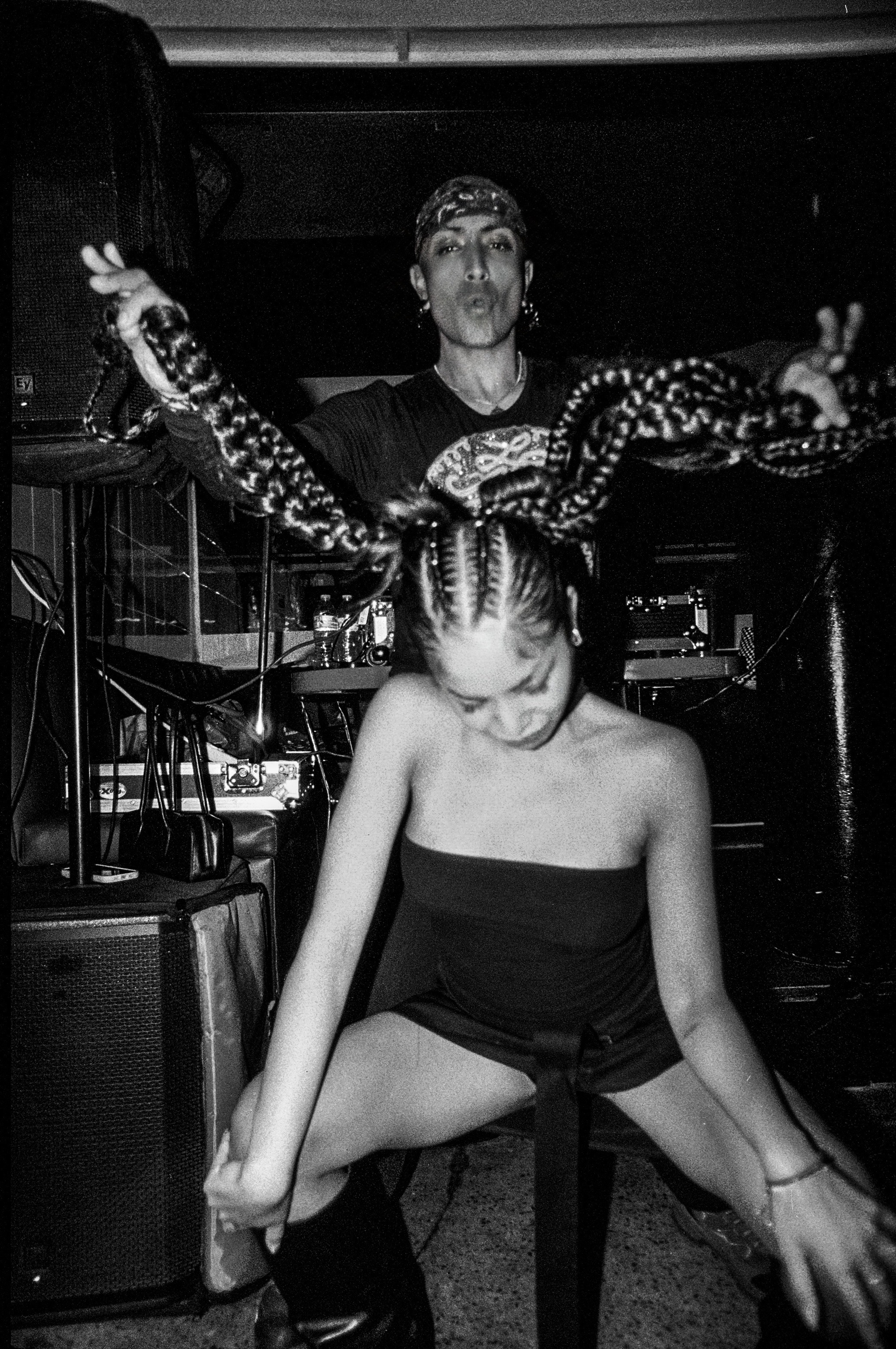 Two dancers at a club in black and white