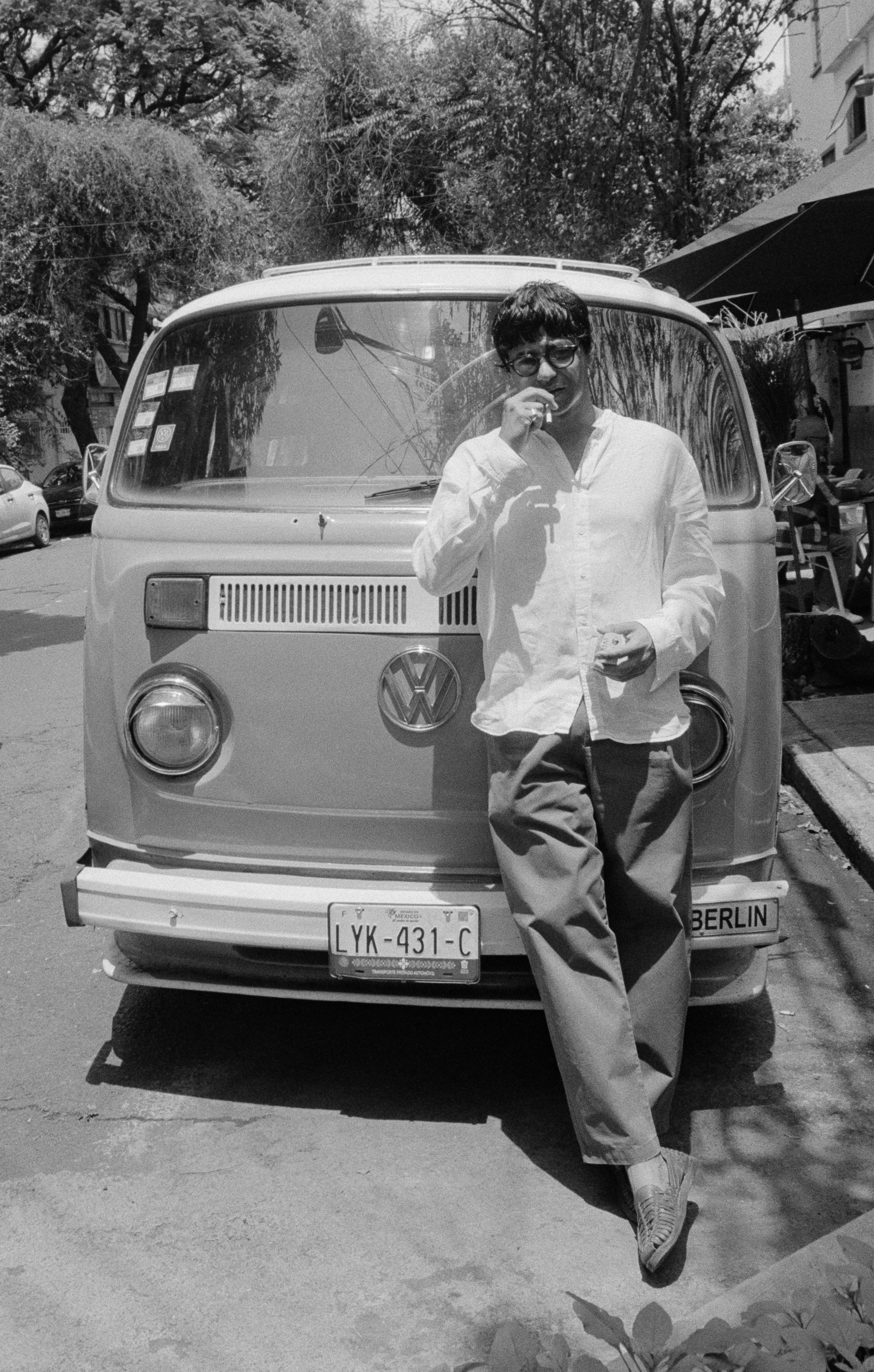 Omar Siddiqi standing in front of a vintage Volkswagen van